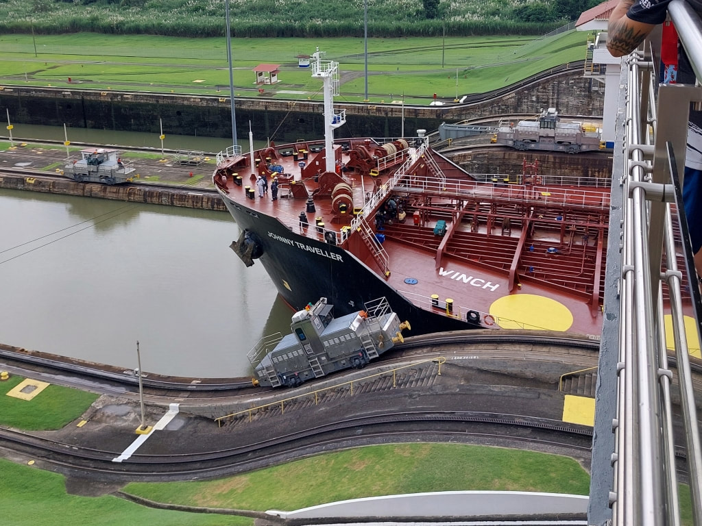 The Johnny Traveller oil tanker being guided through the Panama Canal