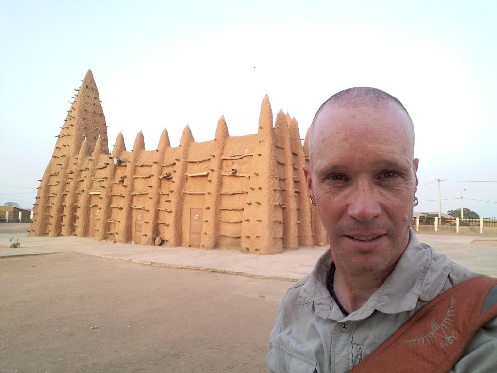 Nomadic Backpacker at the mud mosque in kong, Ivory Coast