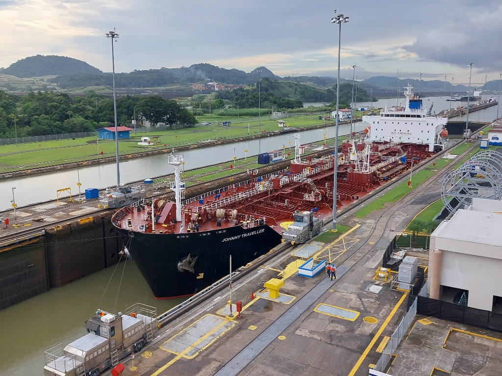 The Johnny Traveller oil tanker being guided through the Panama Canal