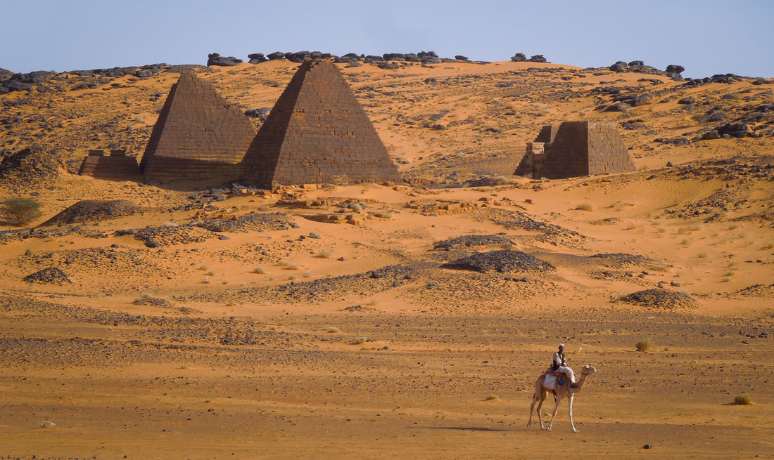 The Meroe Pyramids in Sudan with a man on a camel in the foreground