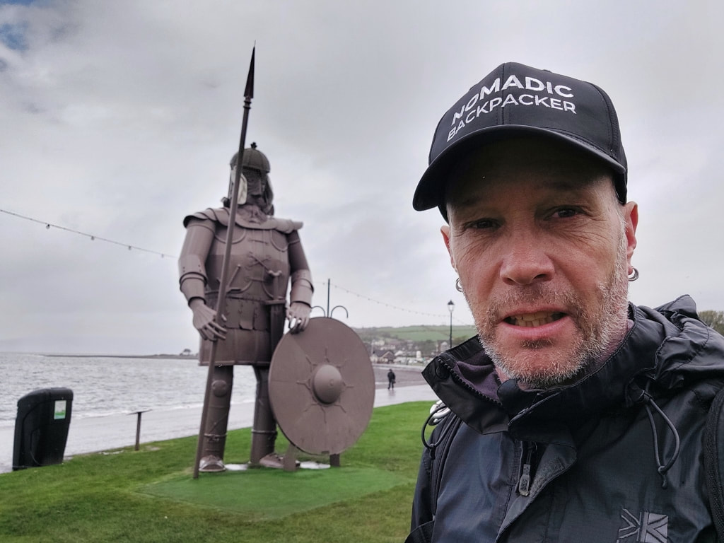 Nomadic backpacker standing in front of Viking Magnus in Largs