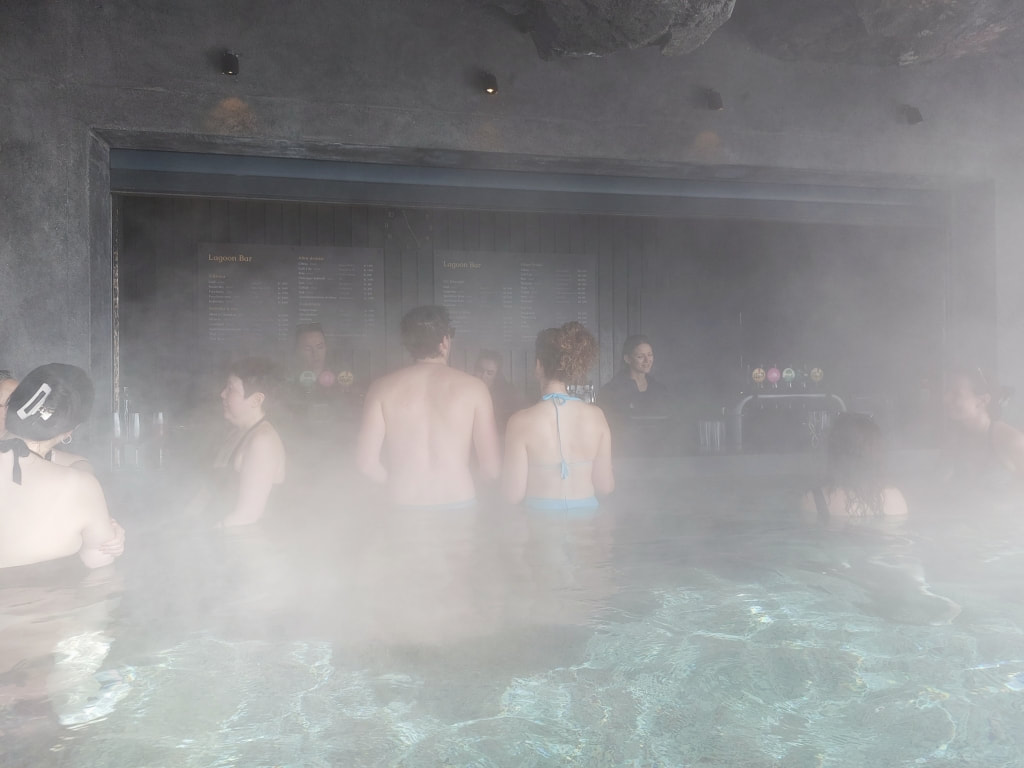 people standing at the bar in the sky lagoon geothermal spa in Reykjavik Iceland