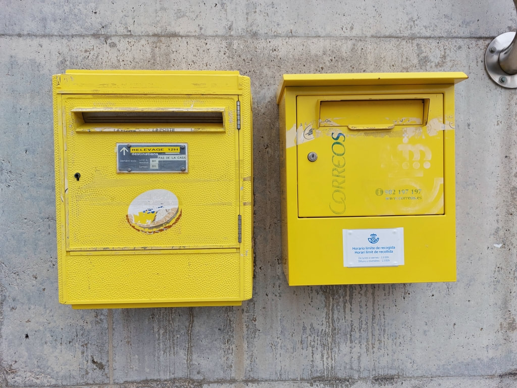 french and spanish post boxes side by side