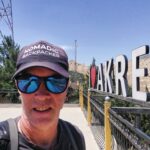 Akre - Historical City - Republic of Iraq - Kurdistan Nomadic Backpacker standing before the I love Akre sign in Kurdistan