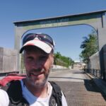 Orange Walk to Bacalar: Crossing the Belize-Mexico border at Santa Elena Using Public Transport Nomadic Backpacker under the Bienvenidos a Mexico sign at Santa Elena