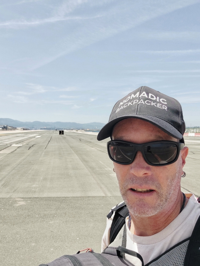 Nomadic Backpacker crossing the runway, entering Gibraltar